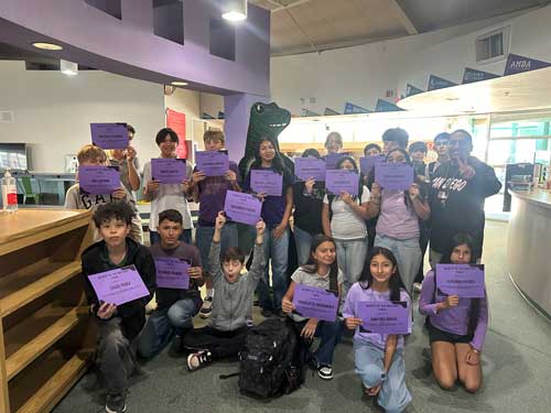 Military Students holding signs for Purple Up Day