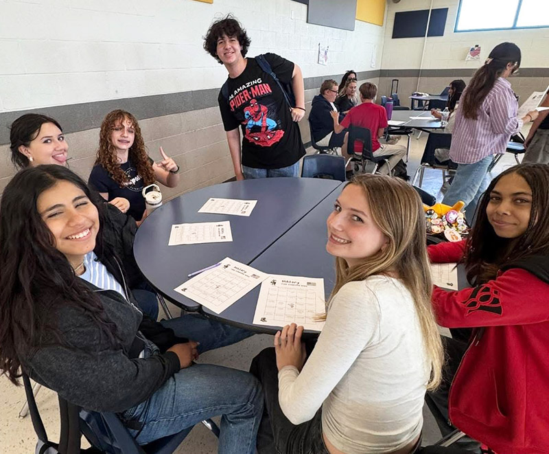 Group of military family students around a round table