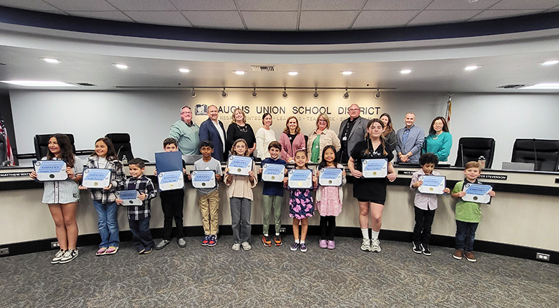 Group of students at a board meeting receiving a special Empathy Award
