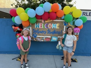 Two happy girls in posing for a picture