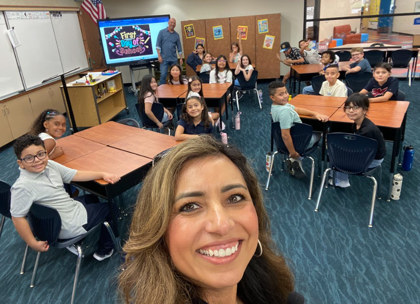 Teacher taking a selfie with her class