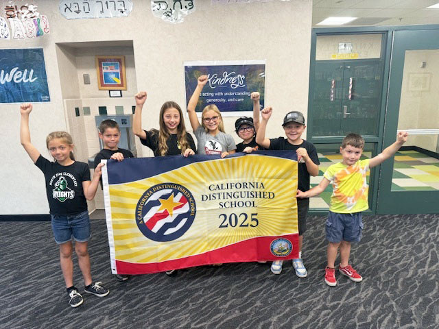 Group of happy North Park students holding California PBIS 2025 Gold award banner