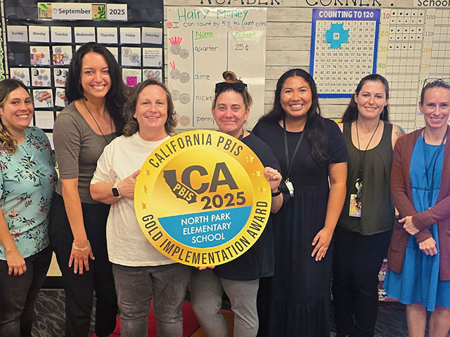North Park staff members happily holding California PBIS 2025 Gold award