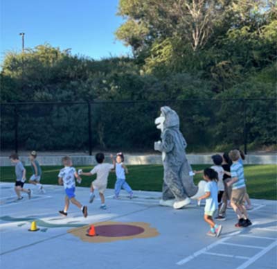 huskie running with students