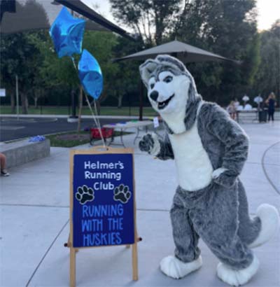 huskie in front of running sign