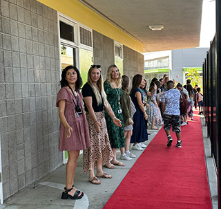 Teachers in a line waiting to greet students