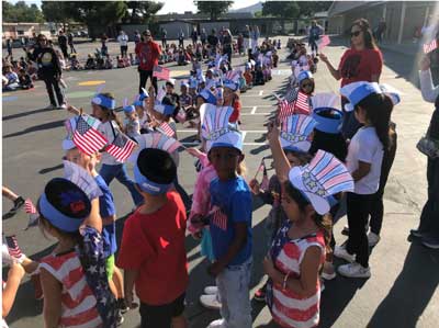 Kindergarteners waving flags