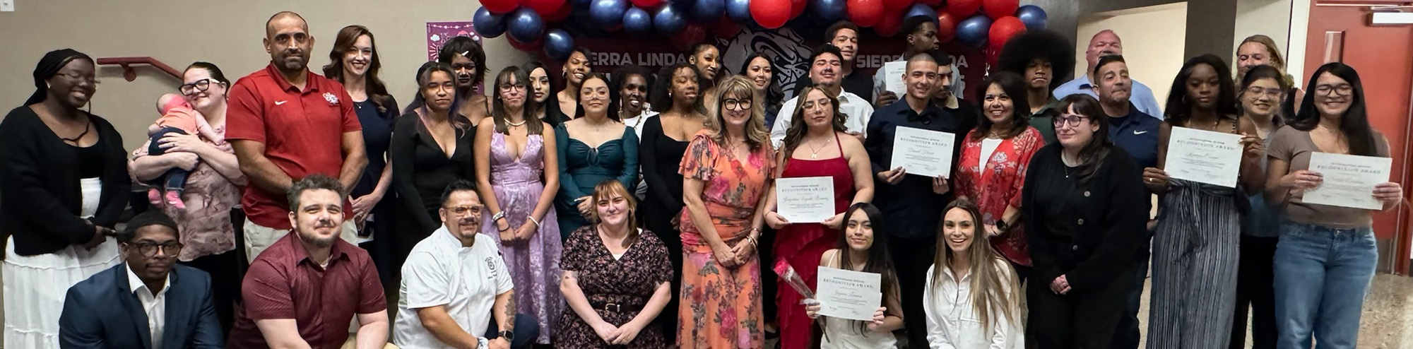 Group photo with some holding up awards