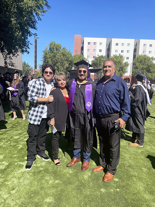 Alumni, Luis Santoyo, with his family after graduation ceremony