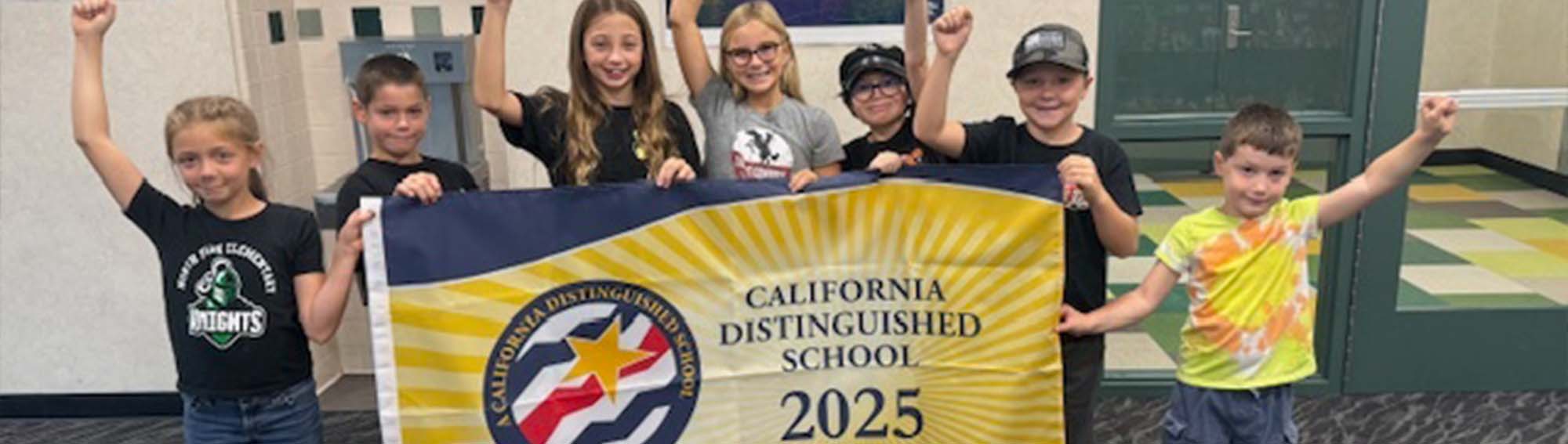 Students holding an award banner