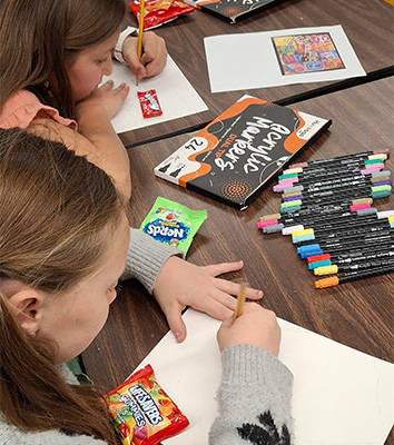 Two students drawing together