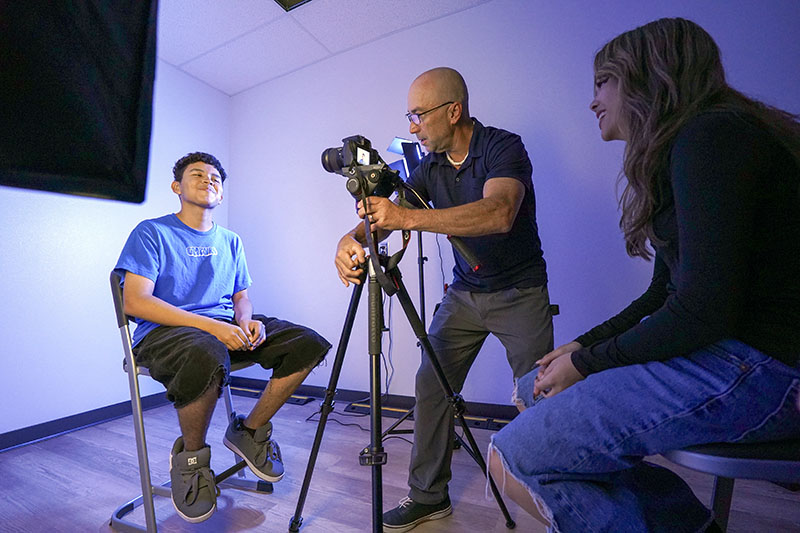 CTE students learning how to take portrait photos
