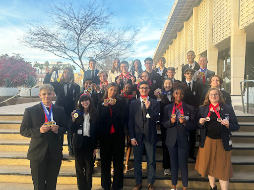 CTE group photo of students wearing red ribbons