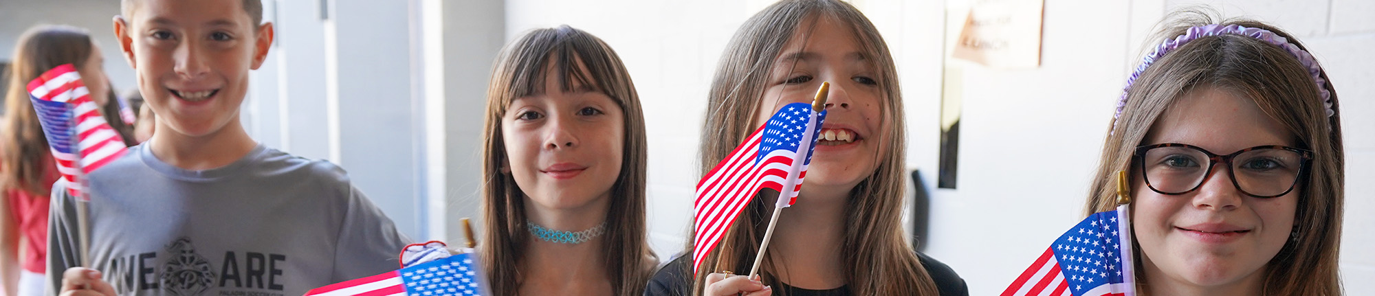 Happy students holding USA flags