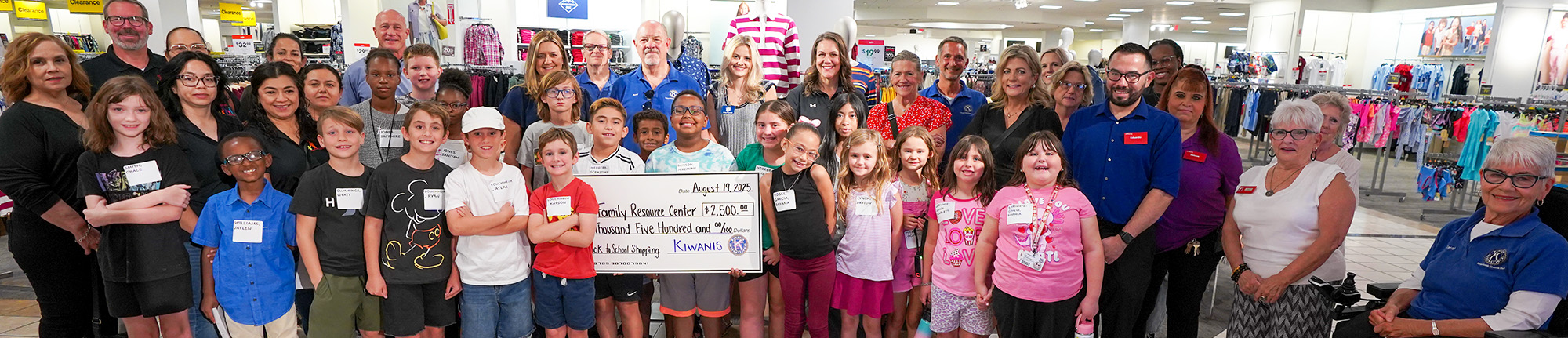 Group of students holding up a check