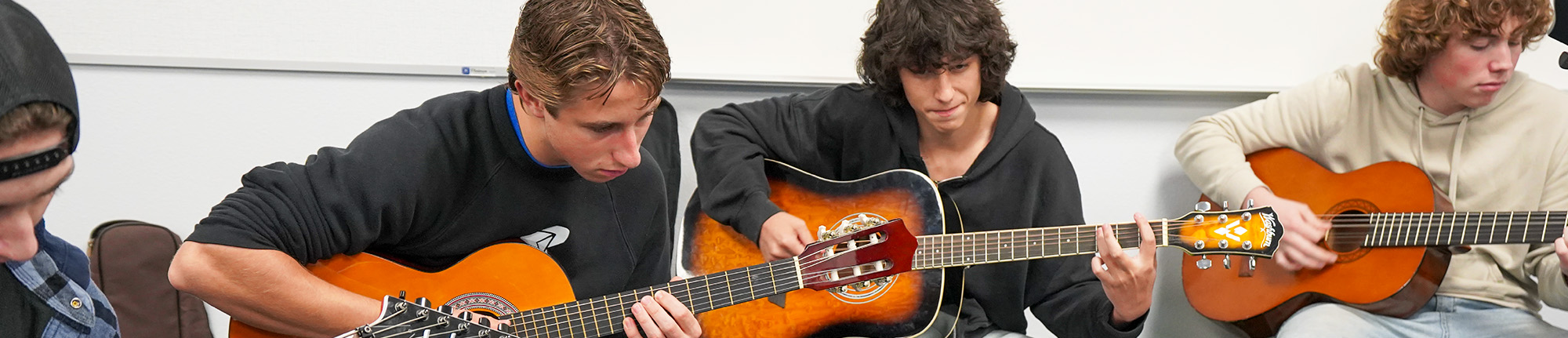 Group of high school students playing guitar