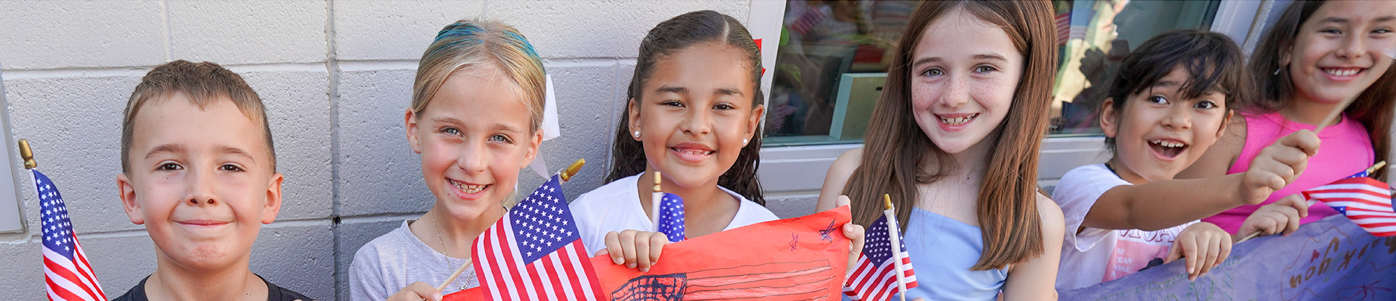 Group of happy students waving USA flags