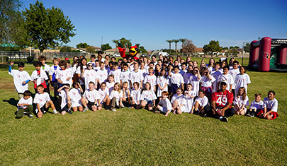 Group of Queen Creek Elementary students that trained with the Arizona Cardinals at a Youth Training Camp on campus