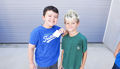 Two happy elementary boys posing for a camera