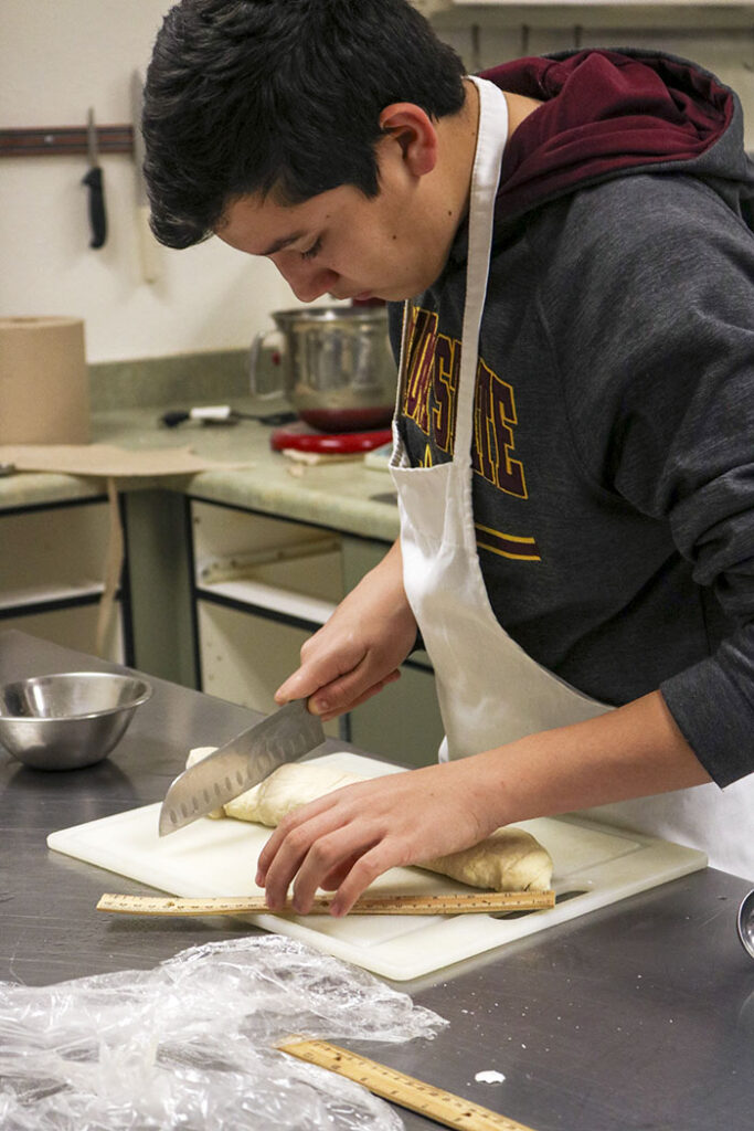 CTE student in the school kitchen making pastries