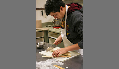 CTE student in the school kitchen making pastries
