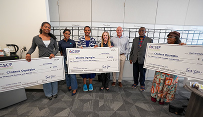 EHS students holding large scholarship checks