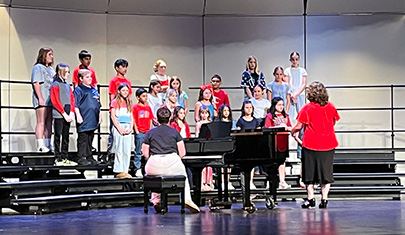 Students singing on stage