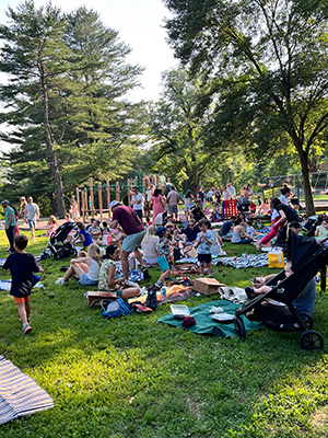 Families sitting on the ground during the end-of-the-year picnic