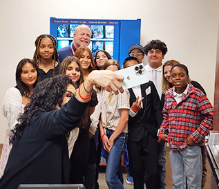 Group of students and teachers taking a selfie