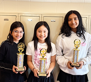 Three happy Scotts Ridge student debate team members holding trophies