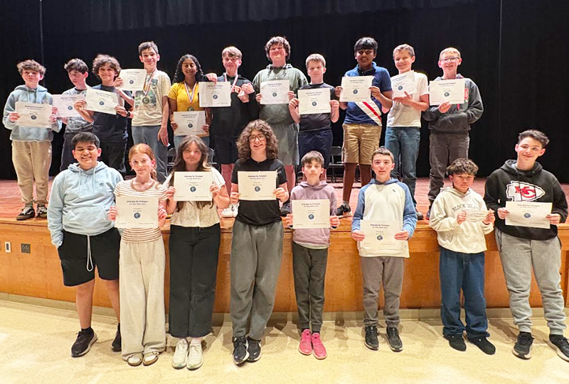 Group of students holding up certificates