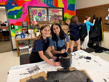Two happy girls working on an art project