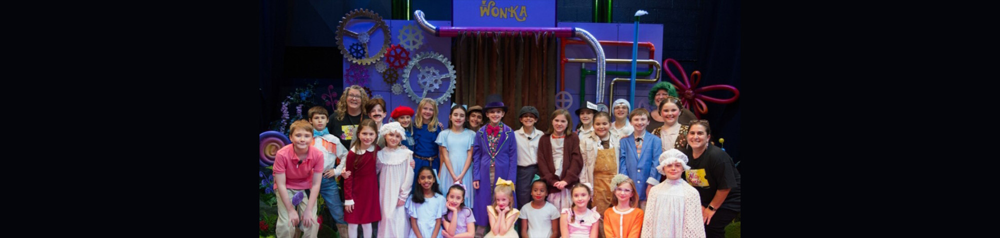 Student actors on a Willy Wonka production stage