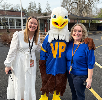 School eagle mascot with two female staff members
