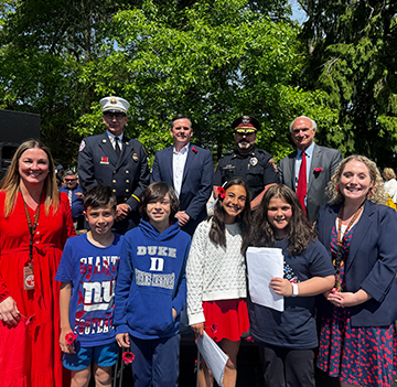 Group of military soldiers with a group of happy students and adults outside