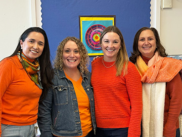 Four happy staff members posing for a picture