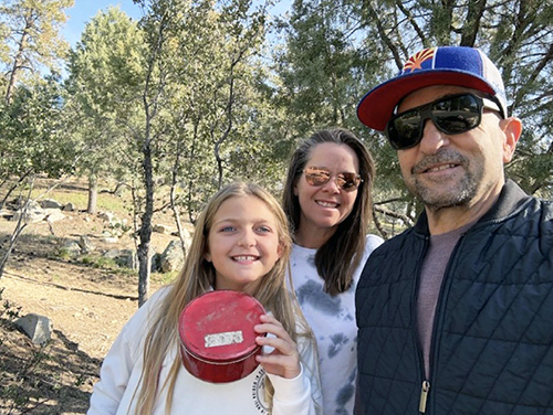 Dr. David Dumon with his family hiking and geocaching