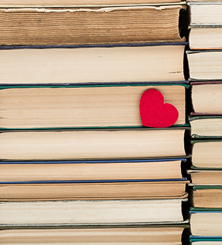 Stack of books with a little red heart