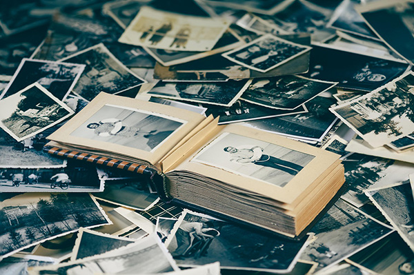 Photo album with many photos around it