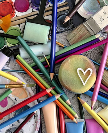 Paints, colored pencils, paint brush