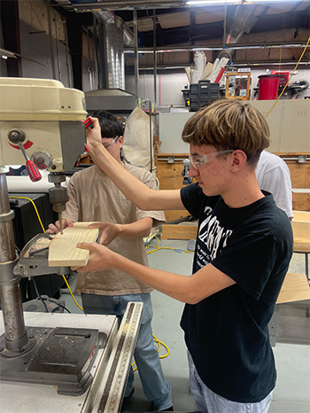 Student using woodworking tools