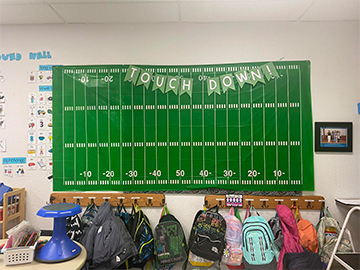 Touchdown bulletin board with student backpacks in classroom