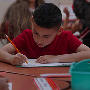 boy writing on paper