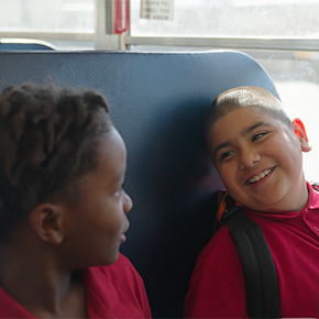two boys lauging on the bus