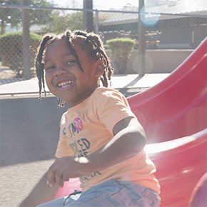 student sliding down a slide