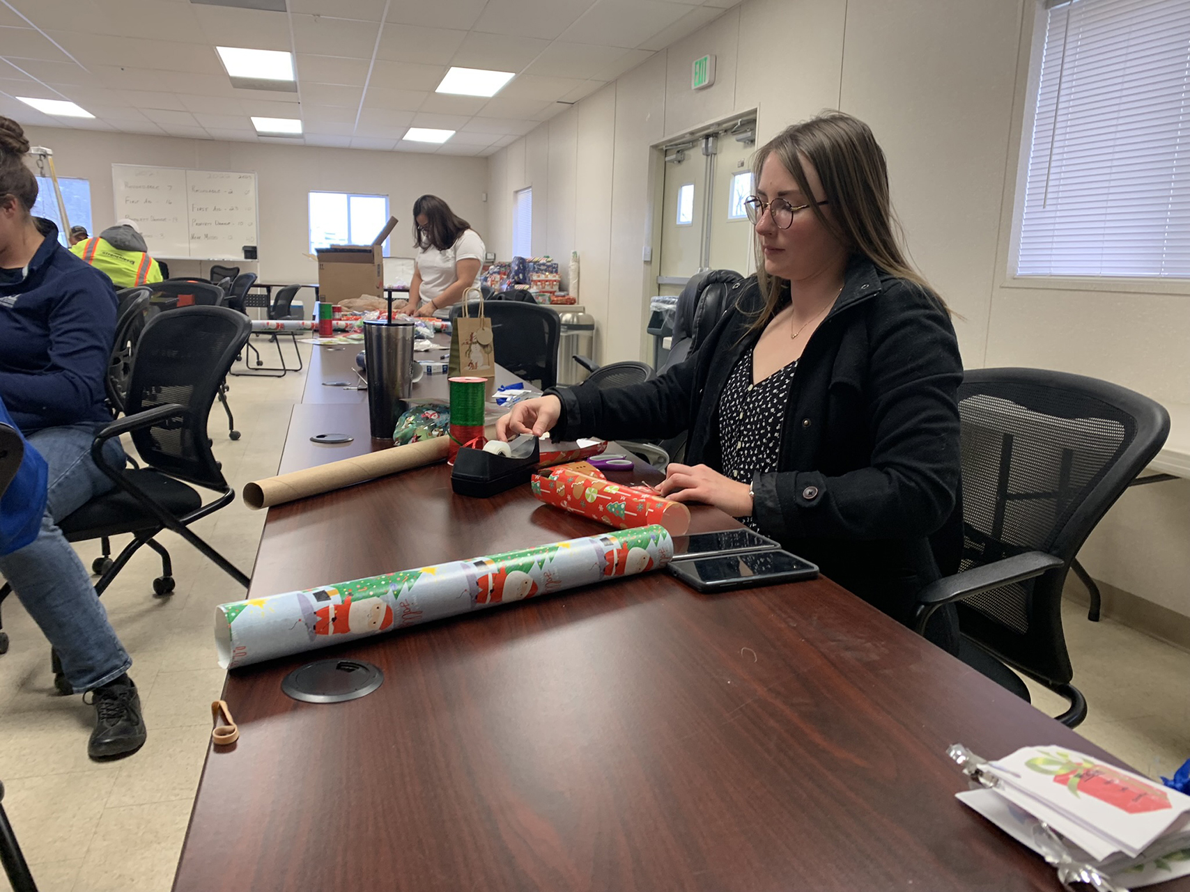 Volunteer wrapping Christmas presents