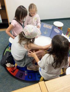 Group of students enjoying reading activities while participating in our Summer Youth Program