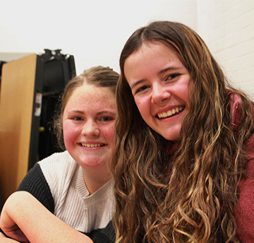 Two happy female students smiling for the camera