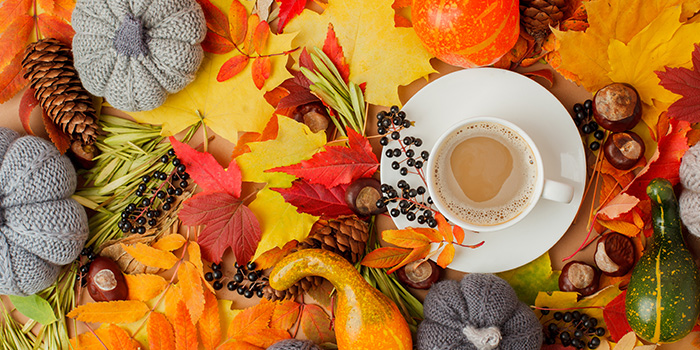 Colorful assortment of fall leaves and cup of coffee