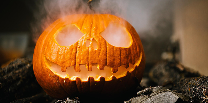 A spooky jack-o-lantern with smoke coming out of it